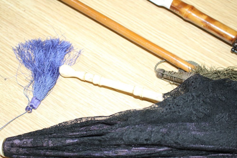 A group of assorted Victorian and later parasols including one with jewelled silver and ivory folding handle